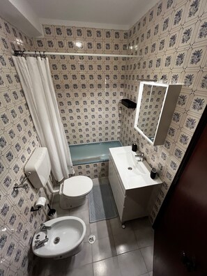 Bidet, towels, toilet paper