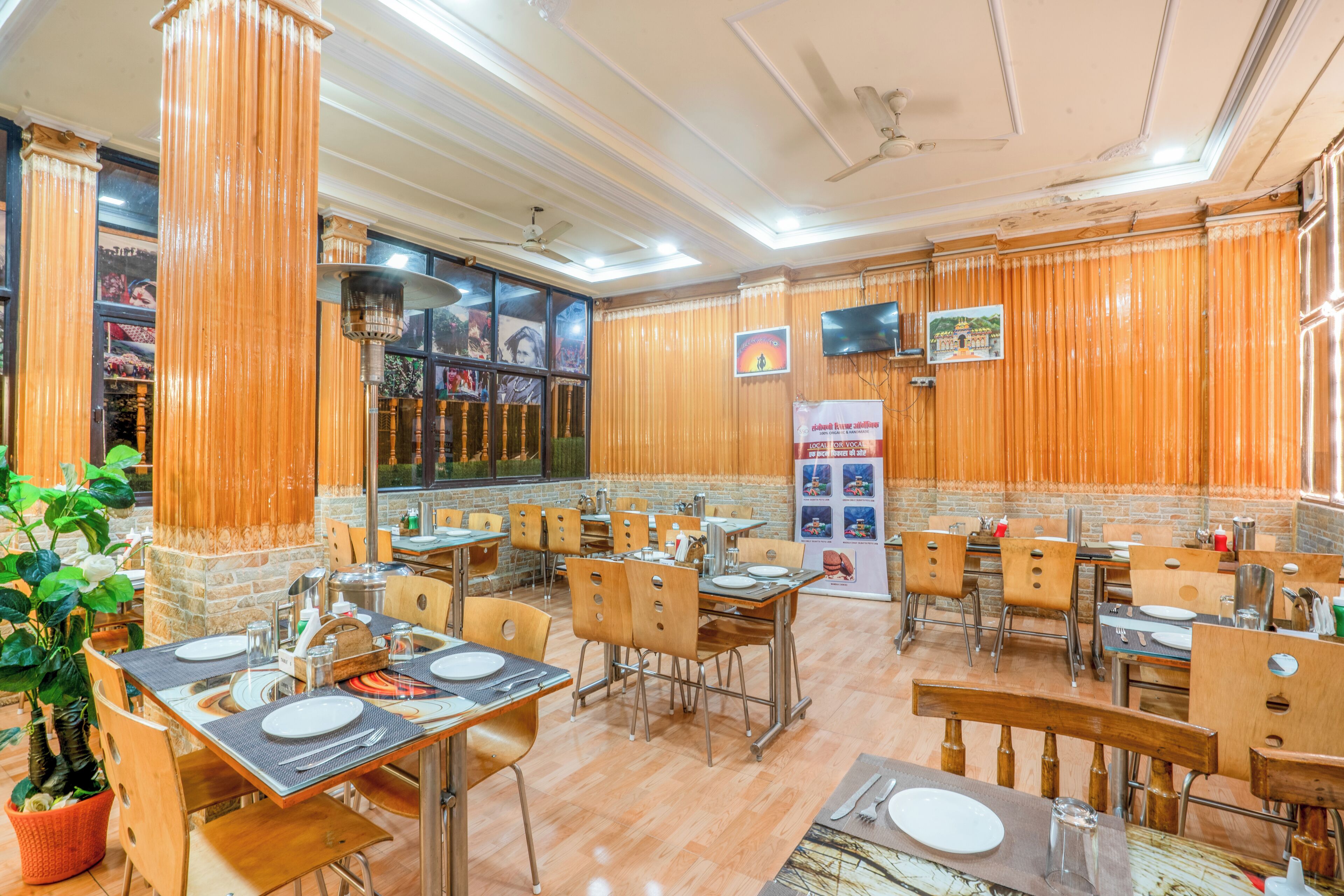 A restaurant with wooden decor, multiple tables, and chairs.
