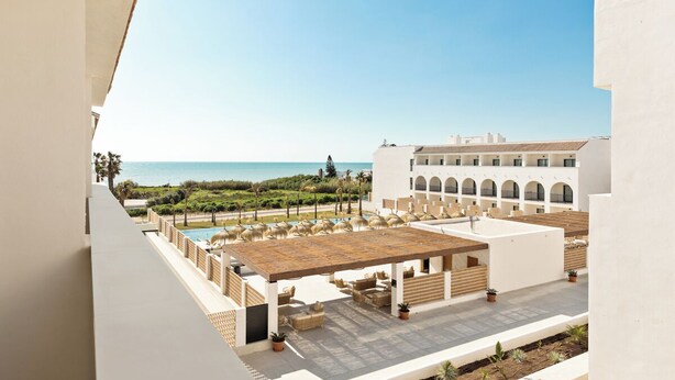 A rooftop terrace with a pool, outdoor seating, and a view of the sea. - Best Village Chipiona (Chipiona)