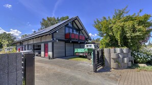 A modern building with a sloped roof, large windows, and a balcony. - Emilia vacation apartment in Trassenheide: WiFi, garden & only 1.9 km to the beach (Trassenheide)