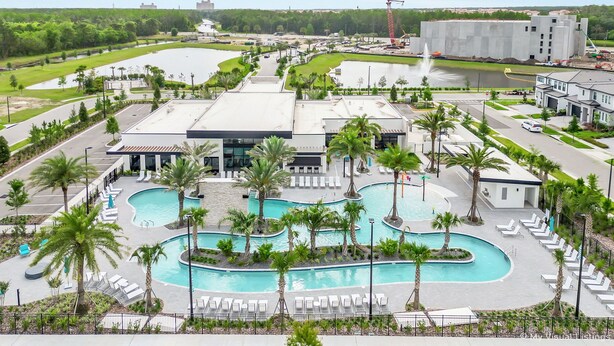 A resort with multiple swimming pools, palm trees, and a large building with a modern design. - 10251 Ebb Tide Lane (Orlando)