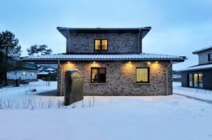 Traditional two-story house with a pitched roof and symmetrical facade.