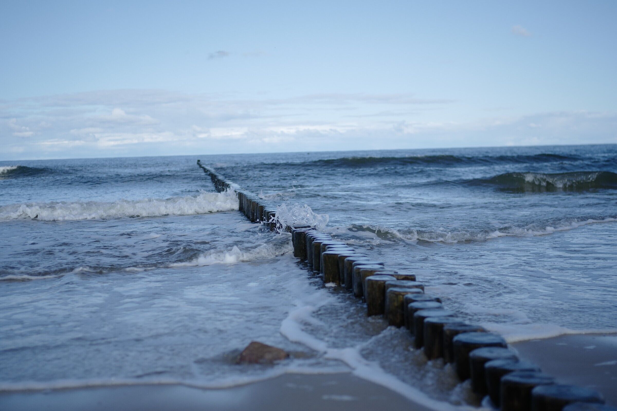 A wooden sea defense structure along a beach.