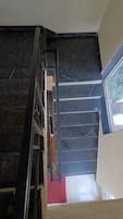 A staircase with dark marble steps and a metal handrail.