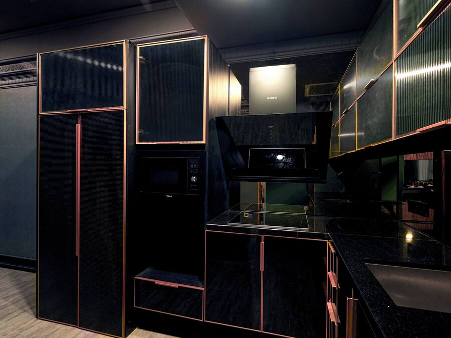 A modern kitchen with a built-in microwave, a refrigerator, and a sink.