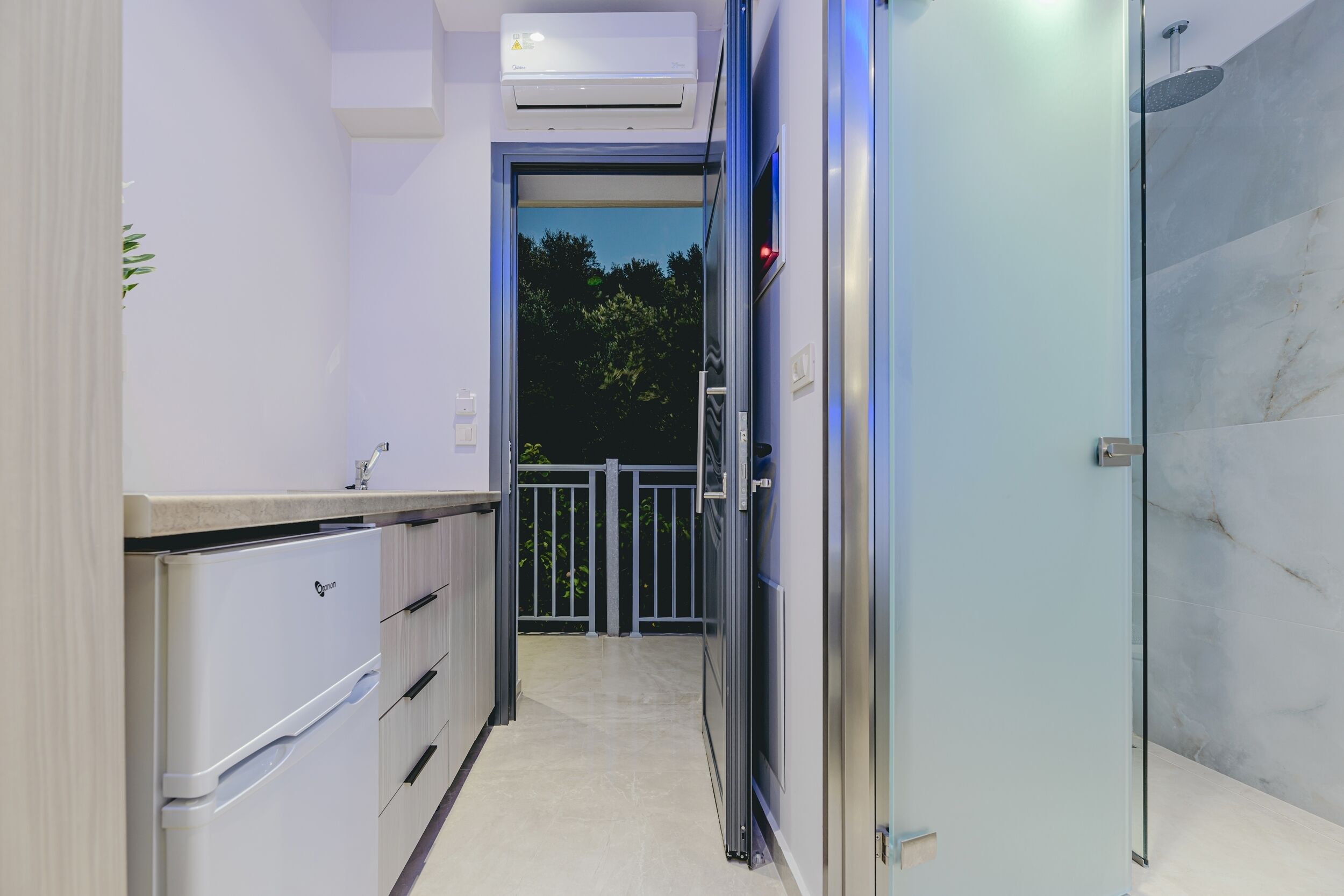 A modern kitchen with a refrigerator, cabinets, and a countertop.
