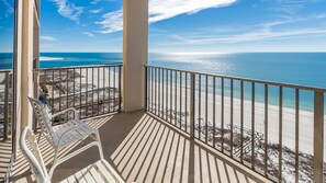 A balcony with a view of a beach and ocean. - Phoenix East 1401 3 Bedroom Condo (Orange Beach)