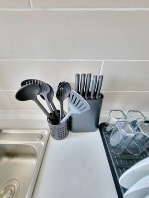 A kitchen counter with various utensils and a container of ice cubes. - leo residence (Nairobi)