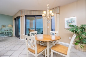 Enjoy meals in this inviting dining area with a round table, comfortable chairs, and a beautiful view.