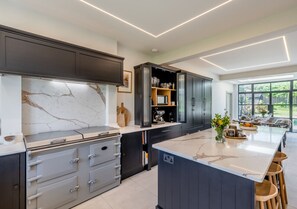 Enjoy cooking in this well-equipped kitchen with oven, ample storage, and a large island with bar stools.