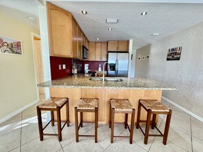Enjoy cooking in this well-equipped kitchen with a central island, sink, and ample seating for four.