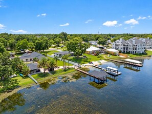 A residential area with houses, a dock, and a clear sky.