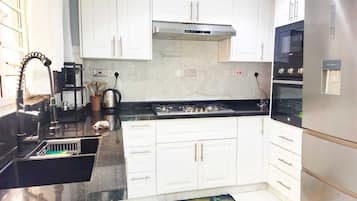 Deluxe Apartment, City View | Private kitchen | Fridge, microwave, cookware/dishes/utensils