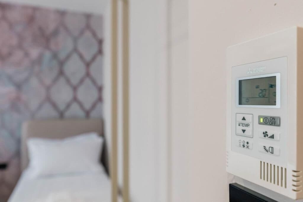 A control panel with a digital display, temperature adjustment buttons, and a power switch.