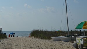 A sandy beach with boats, a lifeguard stand, and a lemonade cart. - Spacious 3 Bed/2 Bath, Sleeps 8 in Ocean Lakes!! (Myrtle Beach)