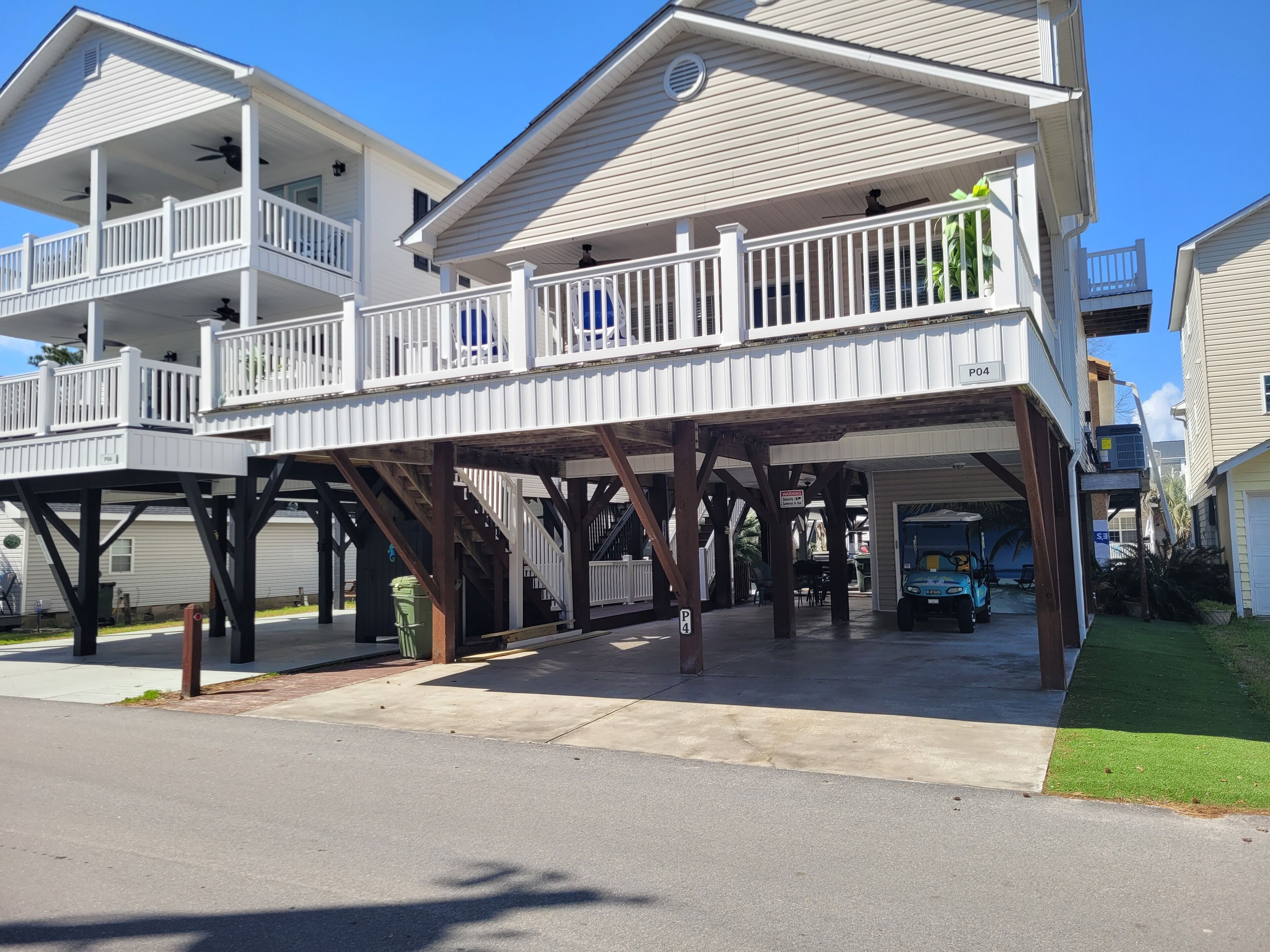A two-story house with a covered porch and a garage.