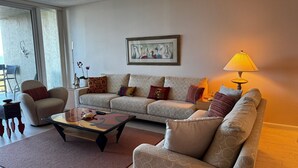 A living room with a sofa, armchairs, a coffee table, and a lamp. - Charming 2-bedroom condo with AC, fitness room in wonderful Longboat Key (Longboat Key)