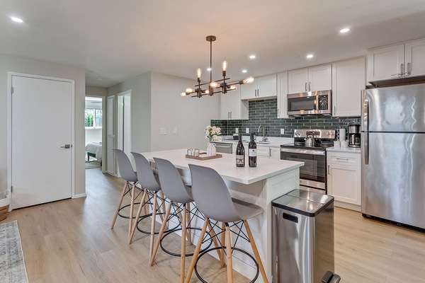 Full kitchen with stainless steel appliances.