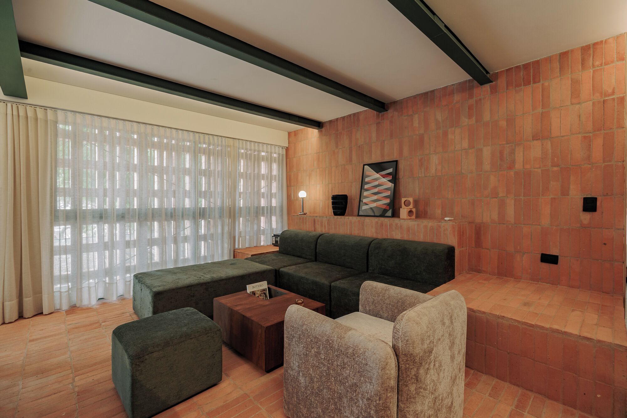 A living room with a sectional sofa, a coffee table, and a fireplace.
