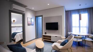 Deluxe Suite | Living area | 50-inch Smart TV with digital channels
