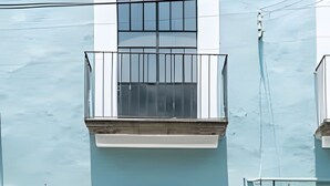 A building with a large, dark-colored door marked with the number 312. - Casona 212 | Stylish Loft w/ High-Speed WiFi (Puebla)