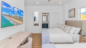 A bedroom with a bed, a desk, a mirror, and a ceiling fan. - 4BR Beach Oasis w/ Private Pool! 1000 ft from the water (Myrtle Beach)