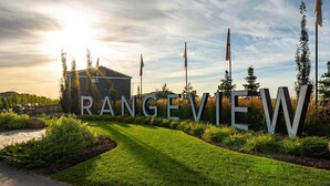 A well-maintained garden with a pathway leading to large letters spelling "RANGEVIEW". - Cozy 3 Bedroom Home in Rangeview (Calgary)
