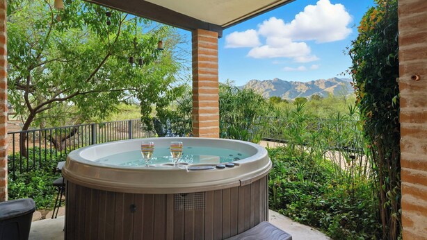 A hot tub with two glasses of champagne on a patio with a mountain view. - Lazy P Ranch 12-acre retreat, spectacular mountain views, bring your horses! (Tucson)