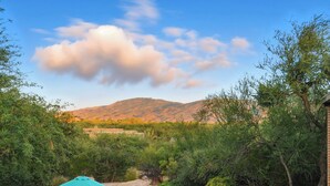A pool area with a view of mountains, surrounded by greenery and a clear sky. - Lazy P Ranch 12-acre retreat, spectacular mountain views, bring your horses! (Tucson)