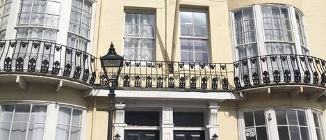 A corner building with a bay window, a black front door, and a sign for 'Central Wave.'