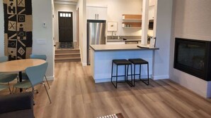 A modern kitchen with a central island, bar stools, and a built-in oven. - Lakefront Condo in Kings Beach-#41 (Kings Beach)