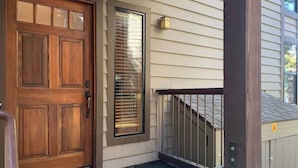 A wooden front door with a glass panel, a small window with blinds, and a metal railing. - Lakefront Condo in Kings Beach-#33 (Kings Beach)
