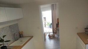 A modern kitchen with white cabinets, a wooden countertop, and a built-in oven. - Very quiet family home a stone's throw from the town center. (Perpignan)