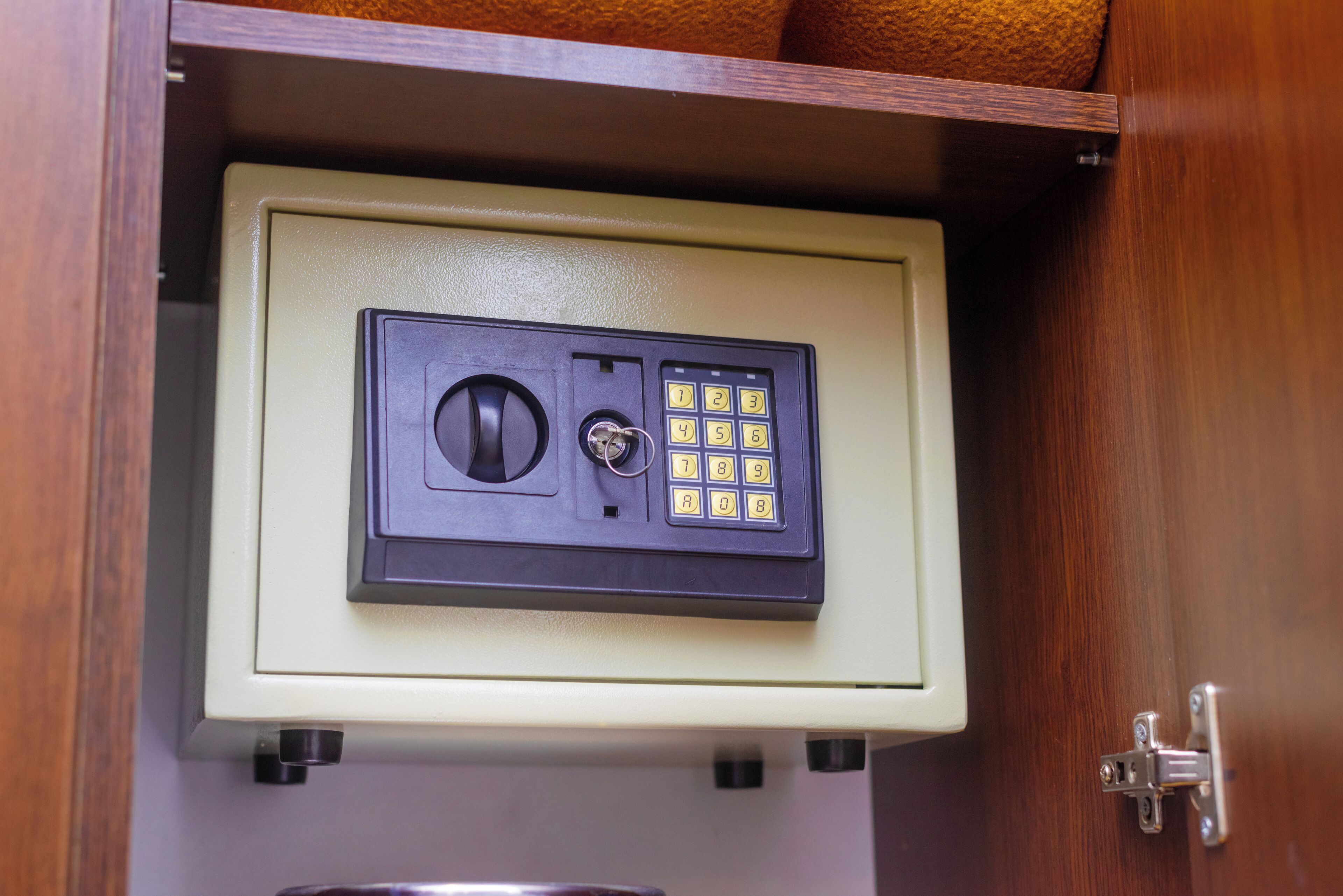 A safe deposit box with a combination lock and a keypad.