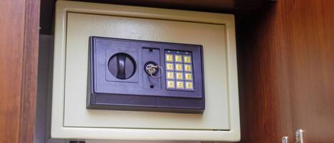 A safe deposit box with a combination lock and a keypad.