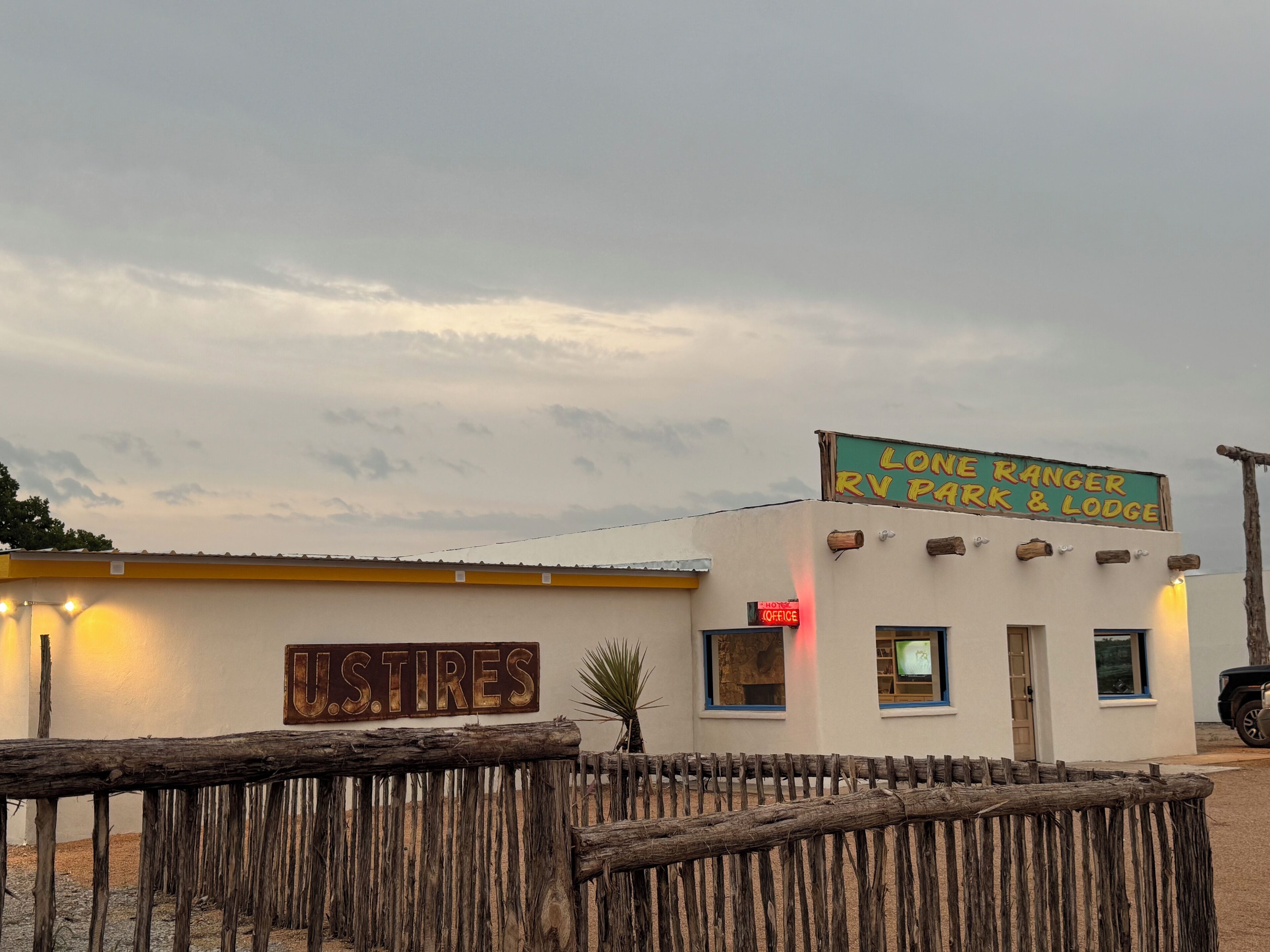 A small building with a sign reading "Lone Ranger RV Park & Lodge".