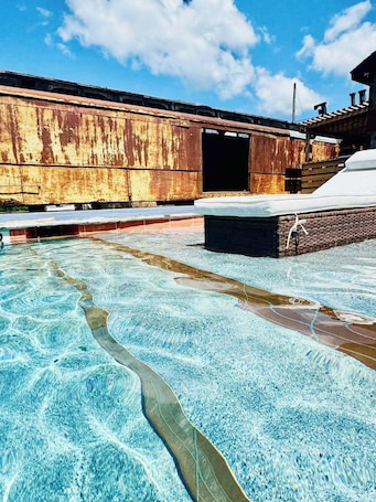 Seasonal outdoor pool, open 8:00 AM to 10:00 PM, pool loungers. Lone Ranger RV Park & Lodge