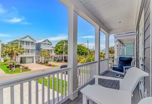 A residential porch with white railings, a blue chair, and a white table. - 300 steps to beach~Private Pool~Elevator~Games~NewHome (Surfside Beach)