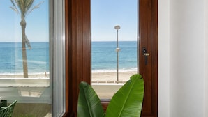 A wooden door with a view of the beach, palm tree, and street lamp. - Comeback El Mar Ciega tus Ojos (Torrenueva)