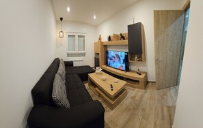 Relax in this stylish living room with a comfortable sofa, coffee table, and flat-screen TV.