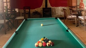 A pool table with balls, a ceiling light fixture, and a red wall with a mural. - Self catering Accommodation for the Larger Group (Ubeda)