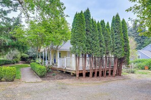 Escape to a serene retreat surrounded by lush greenery and tall evergreen trees.