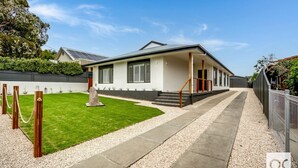 A modern house with a well-maintained lawn, a concrete pathway, and a wooden fence. - Granite Grove - Port Elliot (Port Elliot)