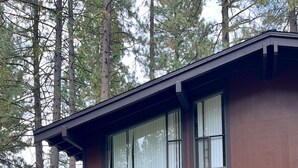 A two-story house with a brown exterior, large windows, and a front porch. - Vacation retreat for golf and enthusiasts and families alike! (Graeagle)