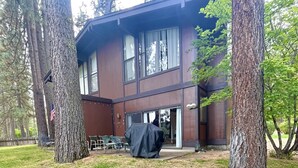 A two-story building with a covered patio area, surrounded by trees. - Vacation retreat for golf and enthusiasts and families alike! (Graeagle)