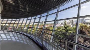 A modern interior with large windows, a curved ceiling, and a view of a cityscape.
