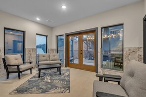Relax in a spacious indoor area with a large sliding glass door leading to an outdoor patio.