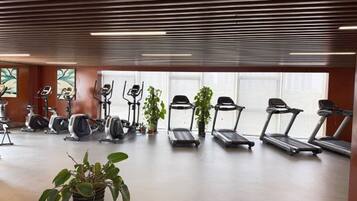 A gym with stationary bikes, treadmills, and exercise equipment.