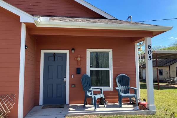 Exterior front porch showing wheelchair friendly walkway from parking pad