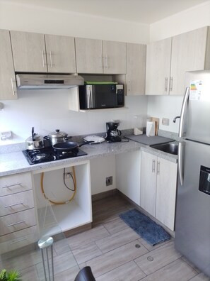 Microwave, coffee/tea maker, toaster, cookware/dishes/utensils